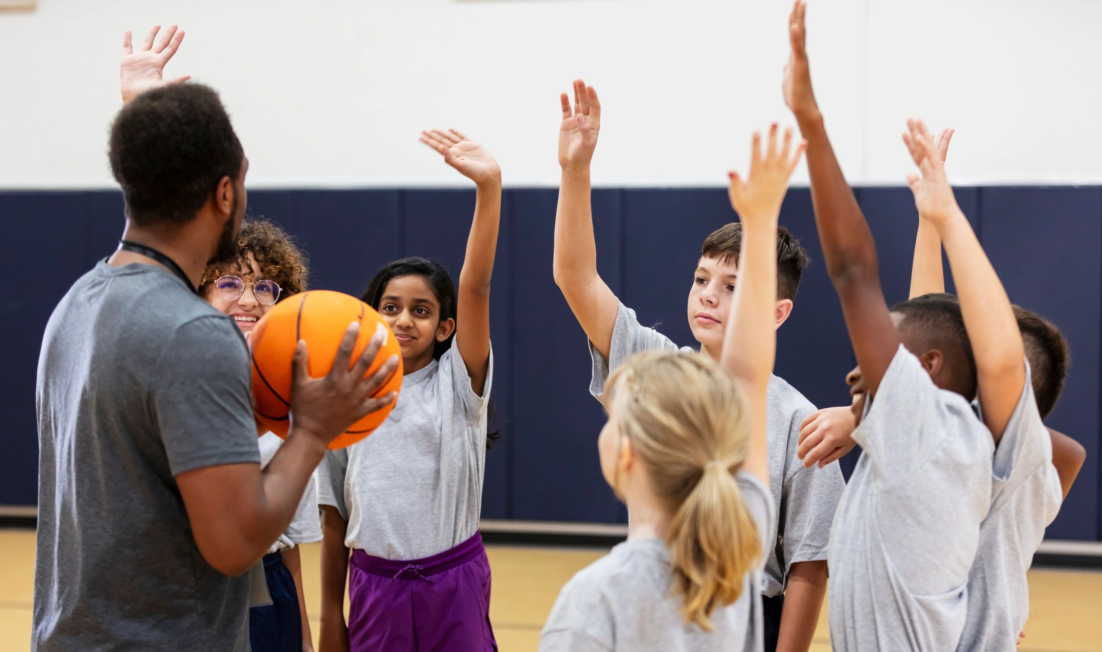 Kids playing a team sport in a gym