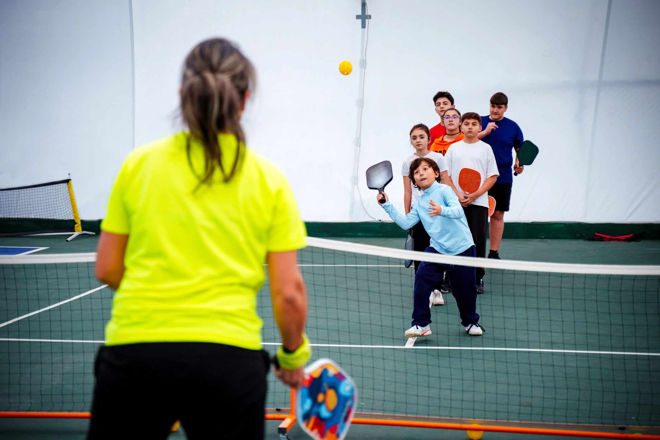 Kids in a group sports session indoors