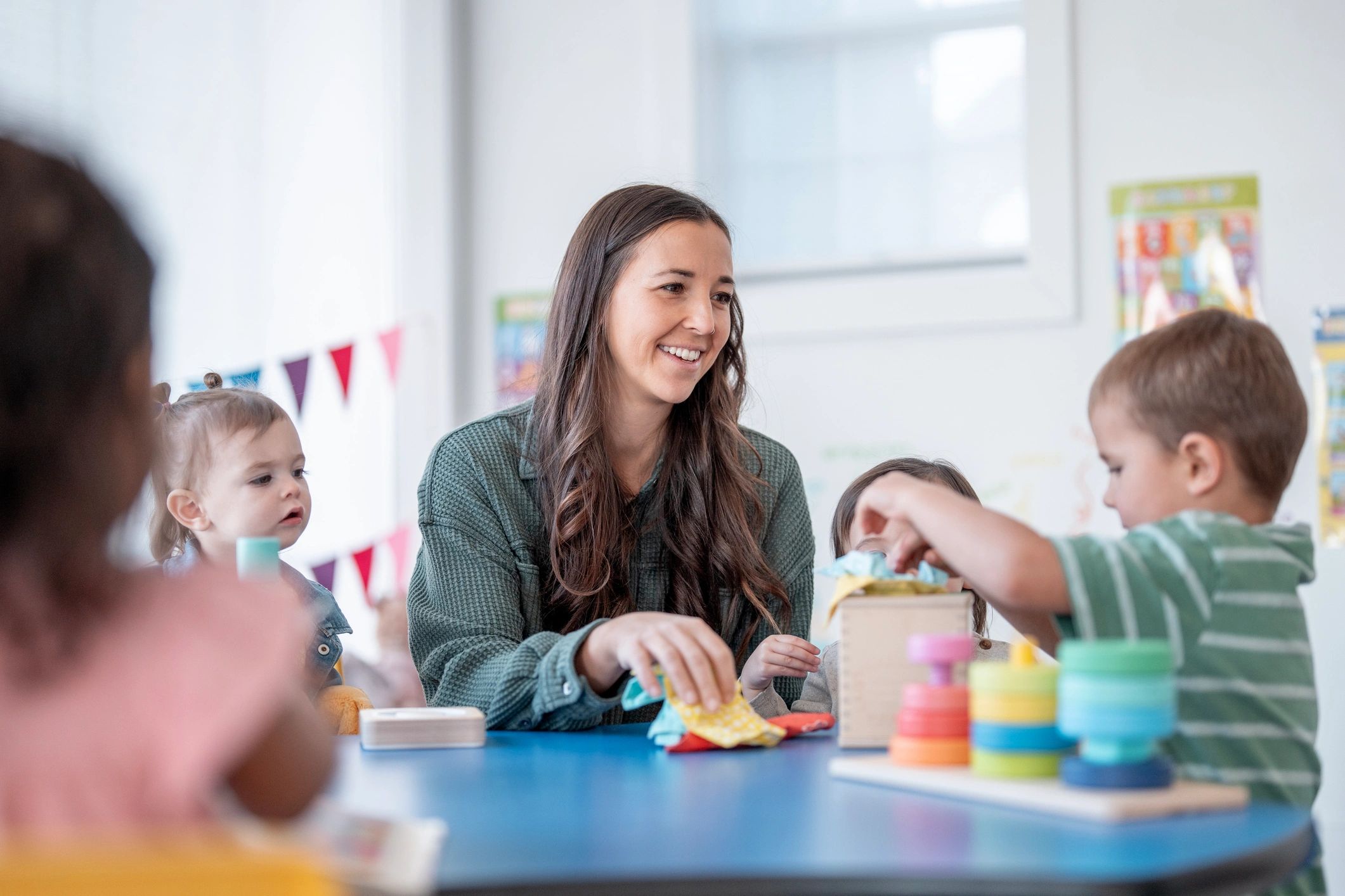 Instructor leading kids at a table activity